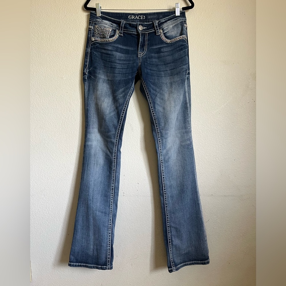 Grace in LA bootcut blue jeans with sequin and embroidery designs. Women’s 29